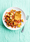 Schnitzel with crushed tomato sauce and fried potatoes