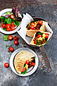 Pita bread garnished with scrambled eggs,merguez and tomatoes