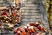 Skewers of meat, vegetables and fruit on the barbecue