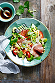 Tortellini salad with speck, tomatoes, capers, basil and parmesan cheese