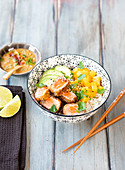 Bowl with crispy salmon, basmati rice, mango, avocado, and Asian vinaigrette