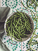 Green beans in a vintage strainer