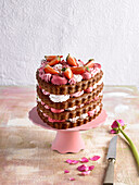 Chocolate layer cake in the shape of a heart with strawberries
