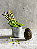 Still life with green vegetables: green asparagus, pea pods, avocado