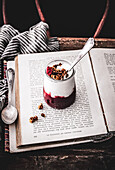 Granola with yogurt, strawberries and rhubarb on a book