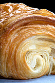 Close up shot of a pain au chocolatshowing the puff pastry