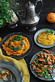 East Asian buffet with carrots, sweet potato puree, and oranges