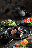 Fusion cuisine menu with tuna tataki in seaweed leaves