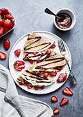 Crepes with strawberries and melted chocolate