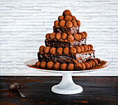 3 tier chocolate cake decorated with truffles