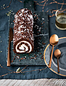 Chocolate sponge roll with coconut cream for Christmas