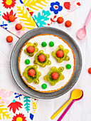 Frozen yogurt cake decorated with fruit turtles