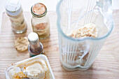 Preparing vanilla milkshake: ice in blender jug next to ingredients