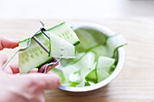 Cut the cucumbers into strips with a vegetable peeler