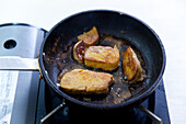 Preparing tuna steak with fried goose liver: Frying the steak in the pan