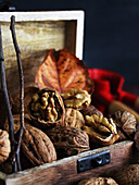 Walnuts with leaves in a wooden box