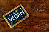 Chalk lettering 'vegan' on school blackboard