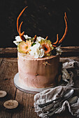 Chocolate layer cake with passion fruit decorated with deer antlers
