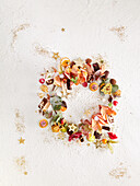 Edible Christmas wreath made of petits fours, chocolate and fruit