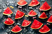 Mountains made of watermelon slices with paper flags on the peaks