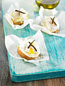 Toasted bread bites with mashed potatoes, poached quail egg, and truffle oil