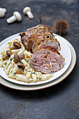 Rolled shoulder of lamb with penne and mushrooms