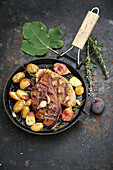 Grilled duck breast with sautéed grenaille and roasted figs in a pan