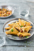 Samosas with pickled vegetables, anchovies and mint