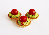 Mini savoury tartlets with courgette cream and cherry tomato