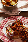 Grilled pork chop with chanterelles