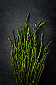 Wild asparagus on a dark base