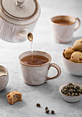 Mini raisin cakes and cups of tea