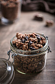 Granola muesli with chocolate in a glass jar with a flip top lid