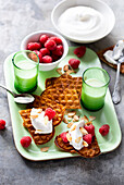 Waffles with whipped cream;raspberries and thinly sliced almonds