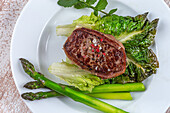 Grilled tournedos on baked leaves