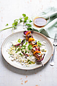 Garam masala chicken skewers with dried apricots and coriander rice