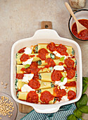 Ricotta and spinach cannelloni gratin with tomato sauce (uncooked)