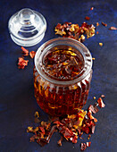 Fragrance oil in a glass with dried red pepper flakes