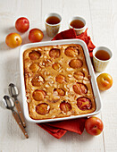 Quick yellow plum casserole with almond flakes