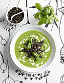 Pea soup with charcoal gremolata and basil