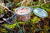 Preparing jars of country paté