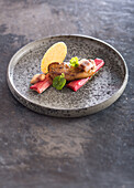 Pan-fried foie gras escalope,rhubarb roasted with honey,smoked eel,spicy juice and a sesame-poppyseed tuile