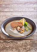 Pan-fried foie gras escalope with Rigadelle seashells,purple artichokes and saffron