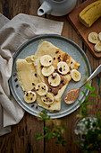 Gluten and lactose-free pancakes with sliced bananas and almond paste