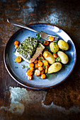 Cod in herb crust,steamed potatoes and glazed carrots