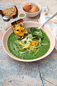 Cold spinach veloute with leek, avocado and toasted bread with cold-cooked egg yolk