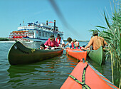 Canoes and shuffle boat on Prerowstrom, Fischland-Darss-Zingst, Mecklenburg-Western Pomerania, Germany