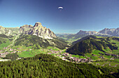 Paragliding over Corvara, Sassongher Mt. Left side, Dolomites, Alta Badia South Tyrol. Italy