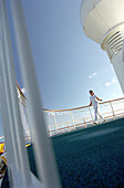 Young womna walking on deck of cruise ship AIDA, Caribbean, America