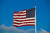 American flag in front of clouded sky, Florida USA, America
